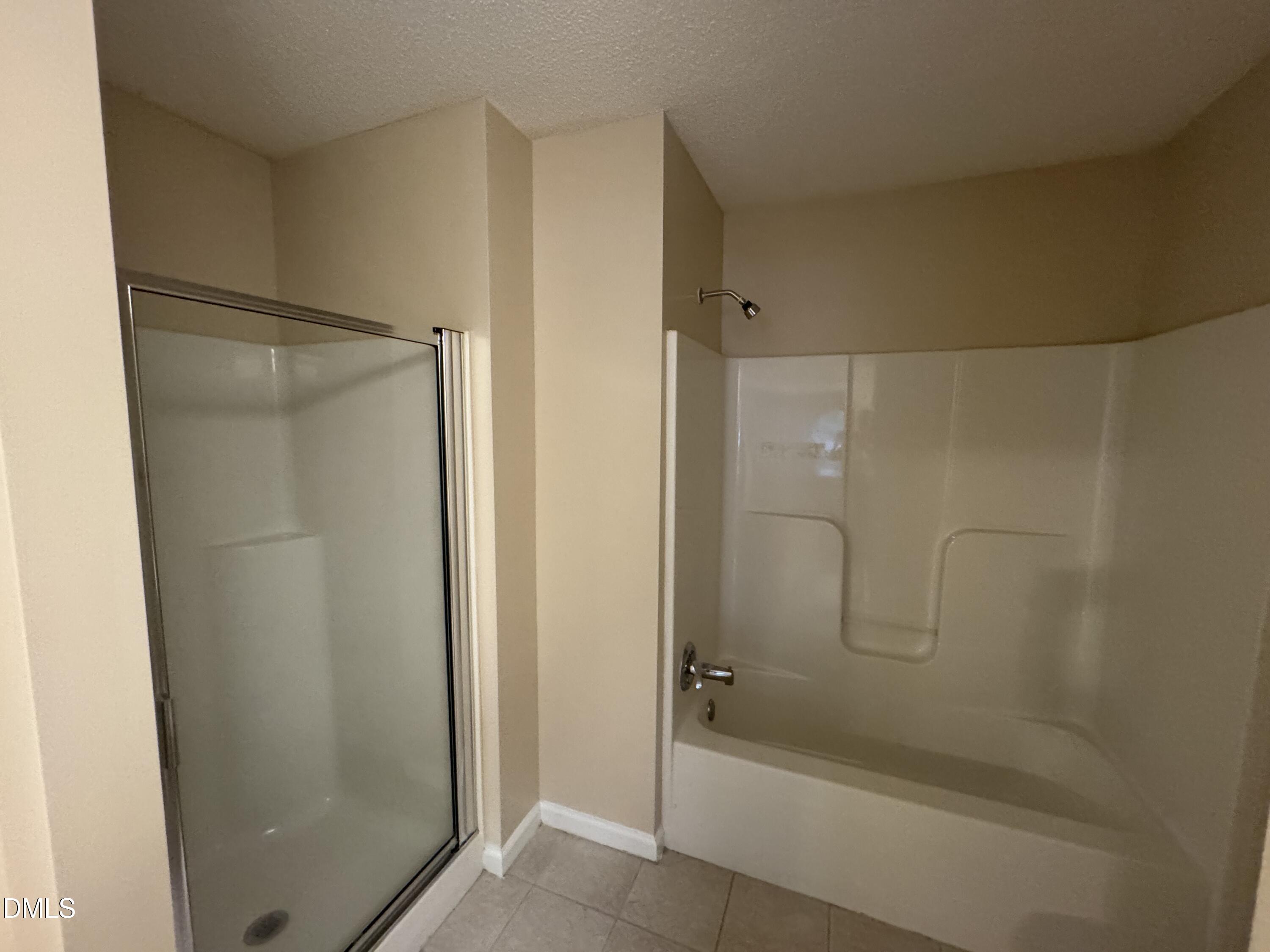 Undisclosed Address Raleigh, NC 27617 - Photo 19 of 22 a bathroom with a shower and a bath tub