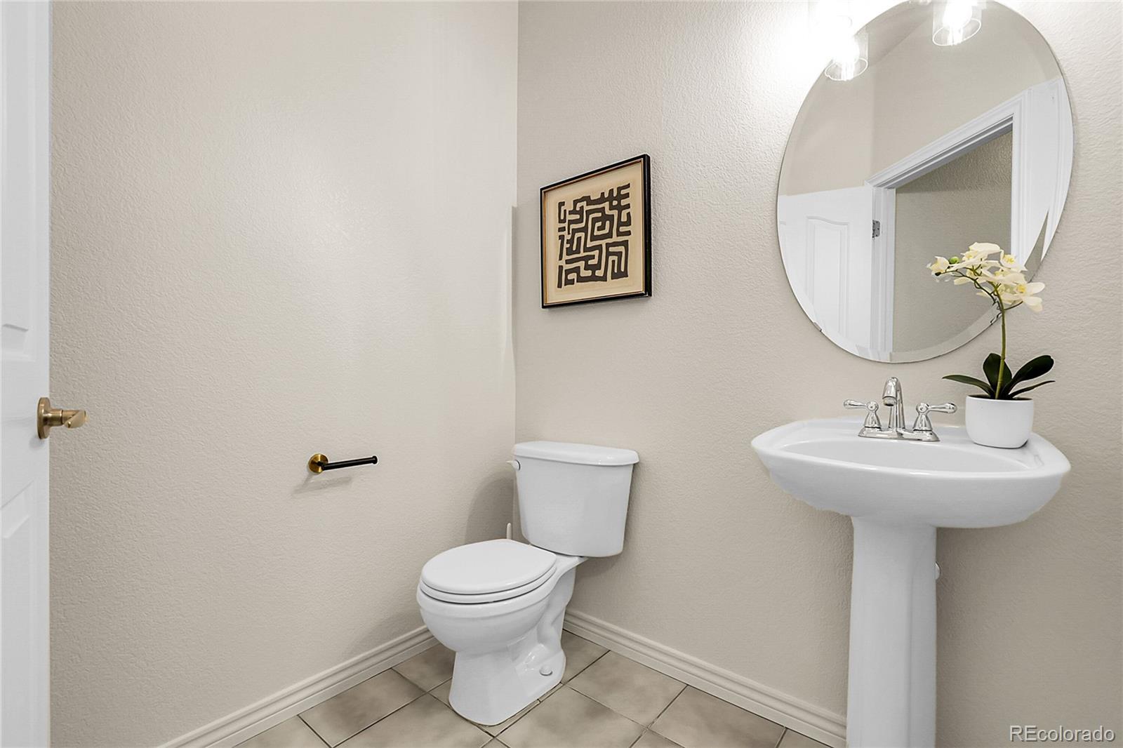 3406 Purcell Street Brighton, CO 80601 - Photo 17 of 50 a bathroom with a toilet sink and mirror