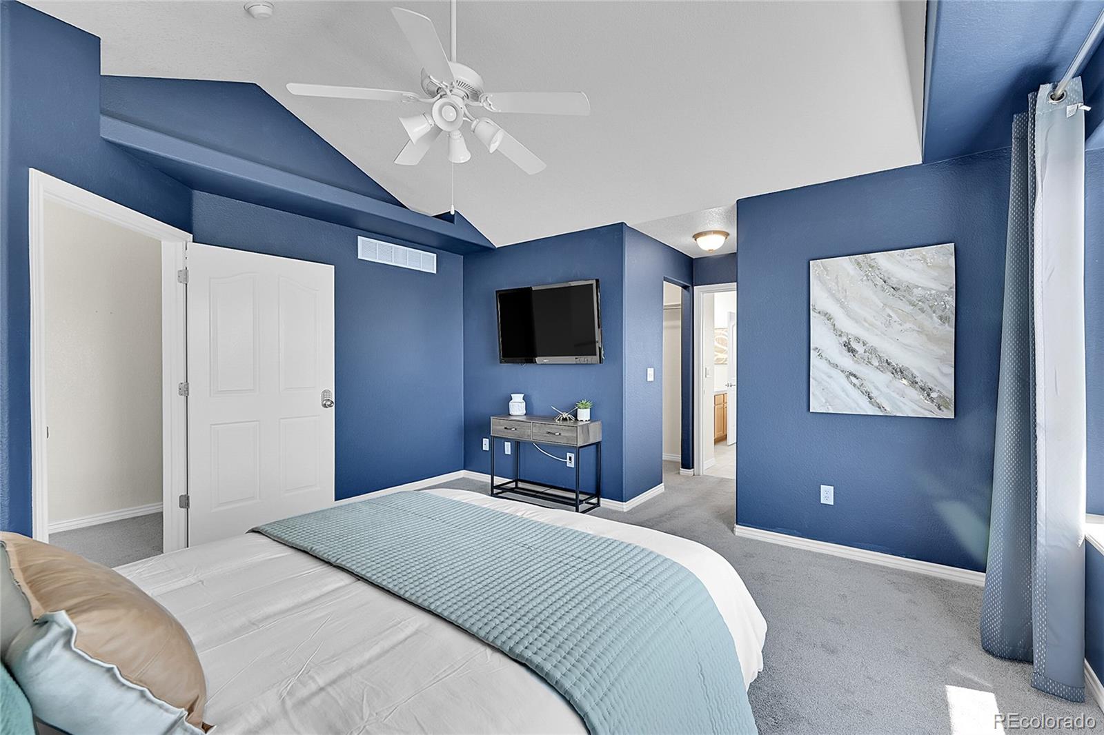 3406 Purcell Street Brighton, CO 80601 - Photo 21 of 50 a bedroom with a large bed and a chandelier