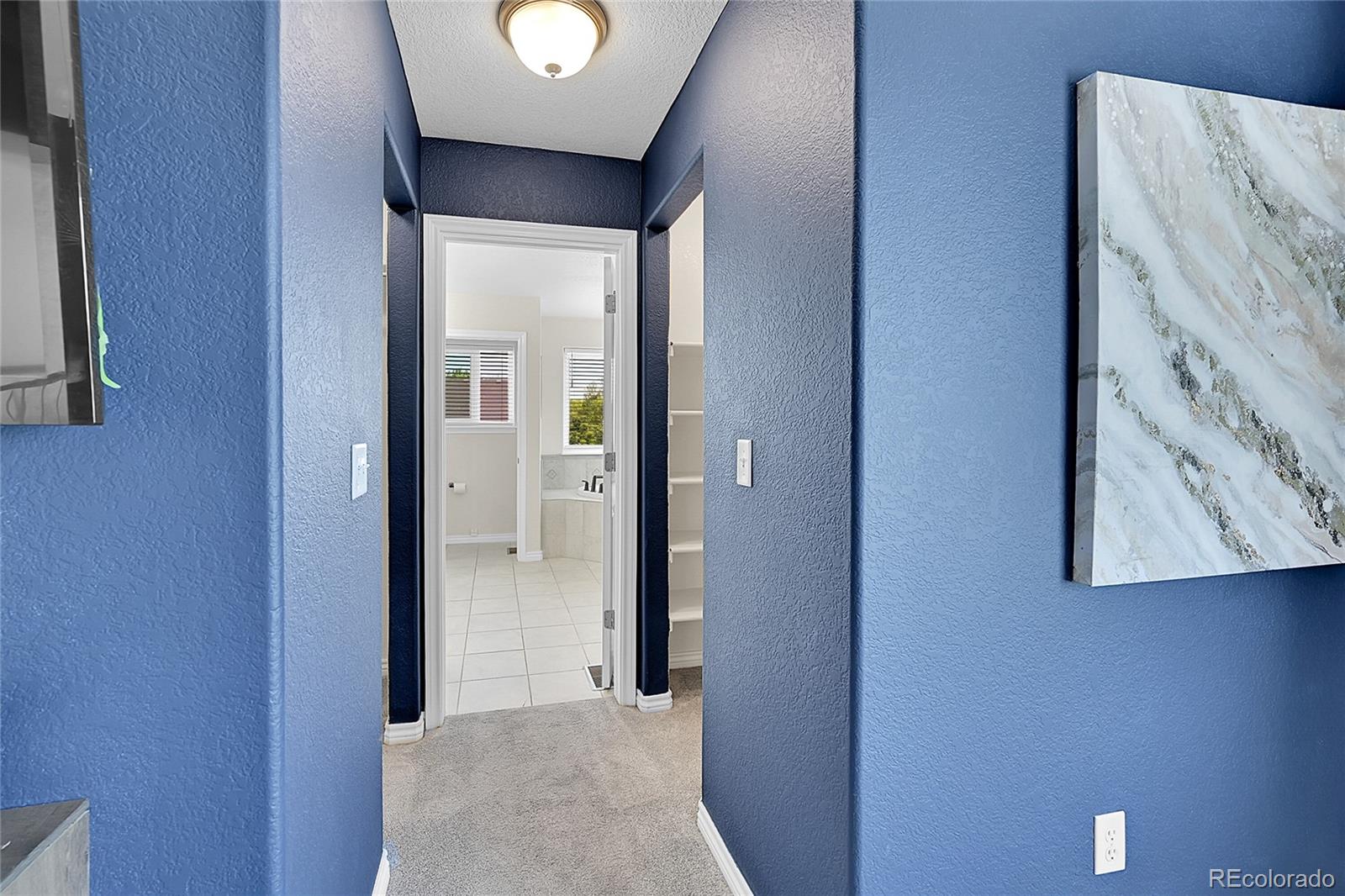 3406 Purcell Street Brighton, CO 80601 - Photo 22 of 50 a view of a hallway with wooden floor and a bathroom