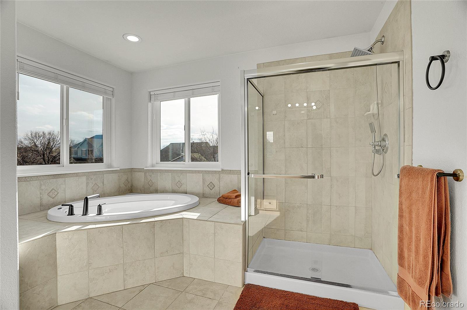 3406 Purcell Street Brighton, CO 80601 - Photo 25 of 50 a bathroom with a tub a sink and a window