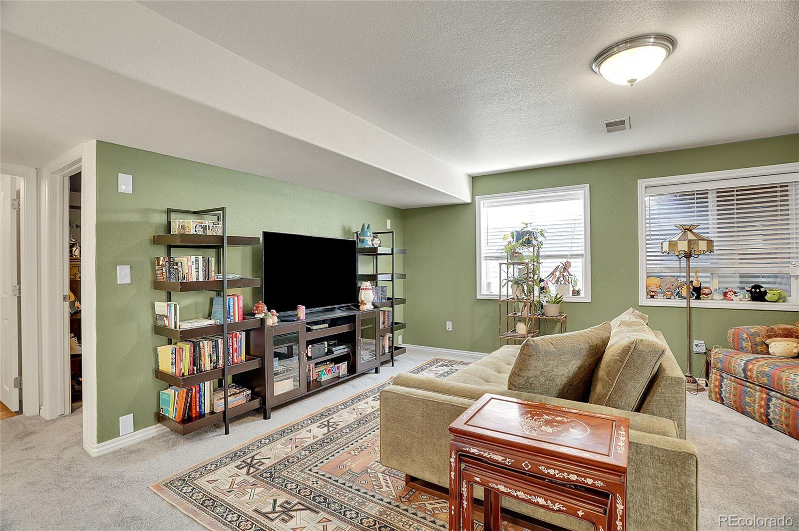 3406 Purcell Street Brighton, CO 80601 - Photo 32 of 50 a living room with furniture and a flat screen tv
