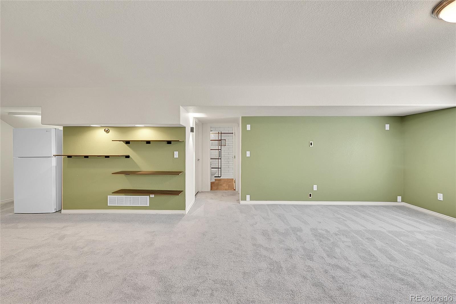 3406 Purcell Street Brighton, CO 80601 - Photo 33 of 50 a view of an empty room with a fireplace and a window