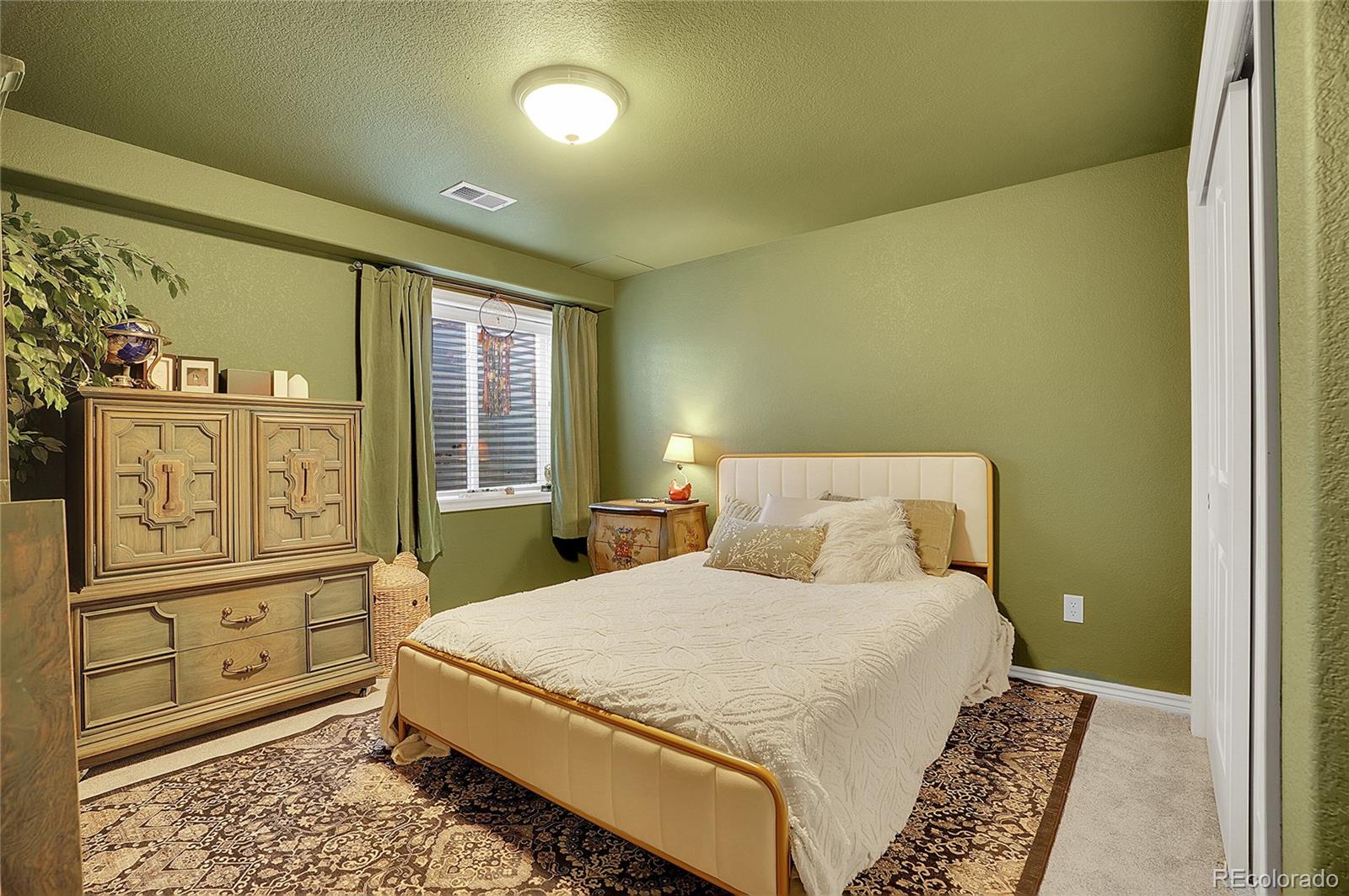 3406 Purcell Street Brighton, CO 80601 - Photo 37 of 50 a bedroom with a bed dresser and mirror