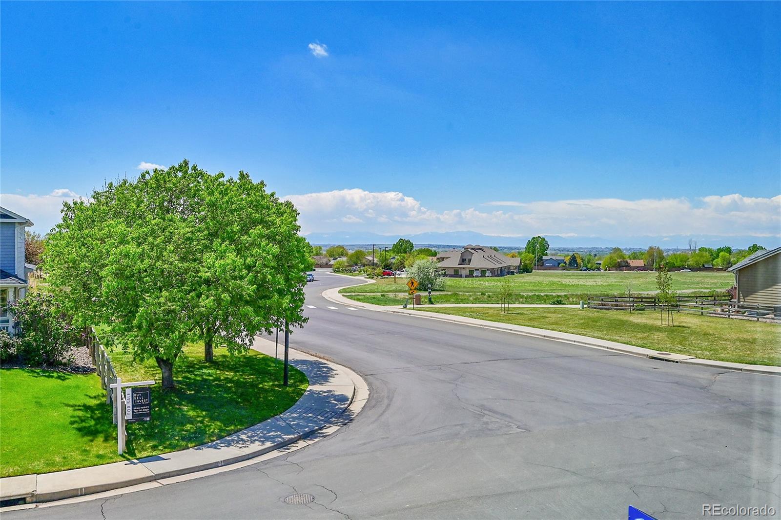 3406 Purcell Street Brighton, CO 80601 - Photo 44 of 50 a view of a road with a big yard and large trees