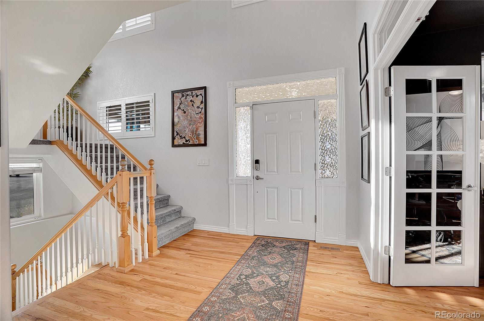 3406 Purcell Street Brighton, CO 80601 - Photo 6 of 50 a view of a hallway with wooden floor and windows