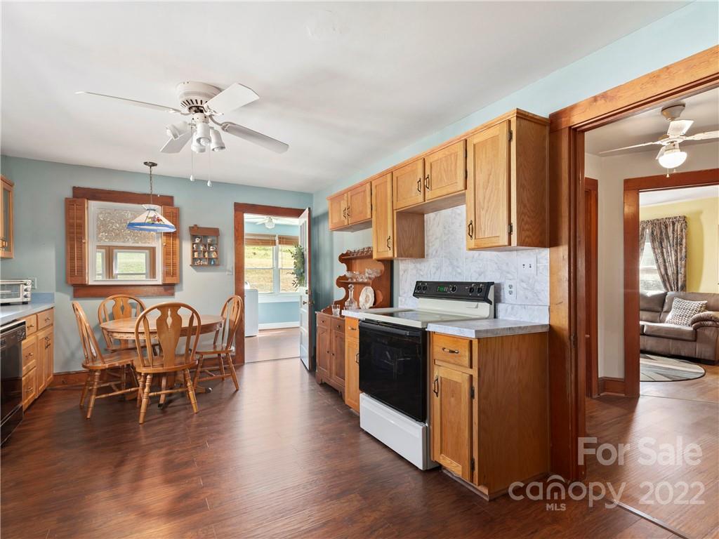 50 Farm House Road Canton, NC 28716 - Photo 12 of 29 a kitchen with stainless steel appliances granite countertop wooden floors and view living room