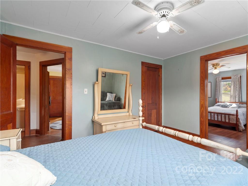 50 Farm House Road Canton, NC 28716 - Photo 17 of 29 a bedroom with a bed and a chandelier