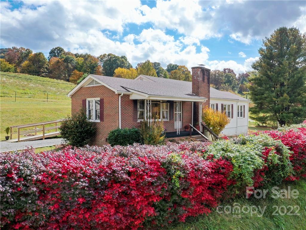 50 Farm House Road Canton, NC 28716 - Photo 2 of 29 a front view of a house with a yard and fountain in middle of the house