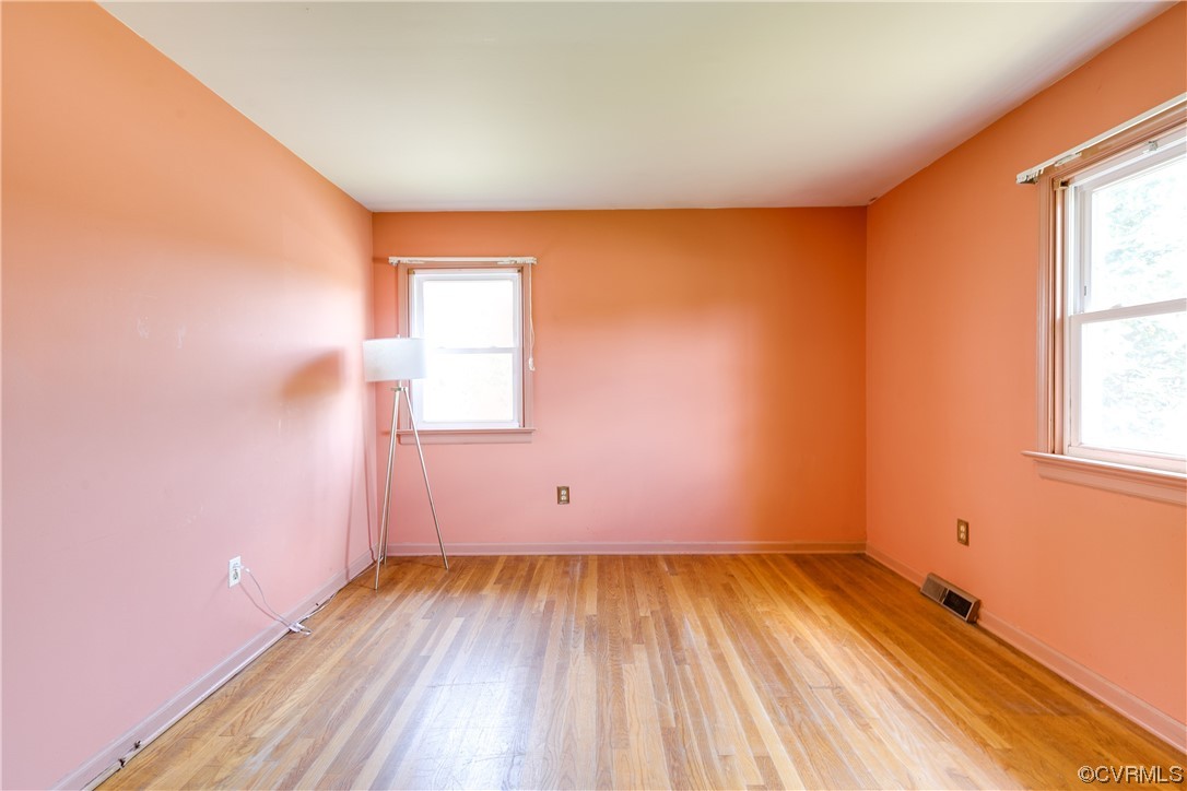 11606 Genito Road Midlothian, VA 23112 - Photo 28 of 48 an empty room with wooden floor and windows