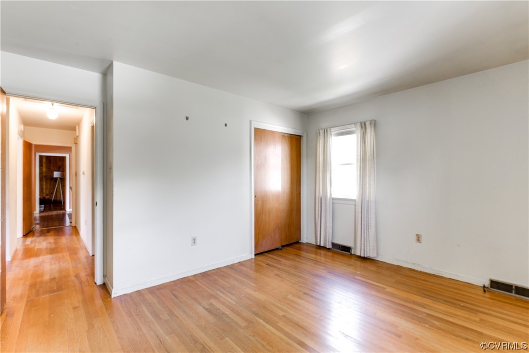 11606 Genito Road Midlothian, VA 23112 - Photo 36 of 48 an empty room with wooden floor and windows