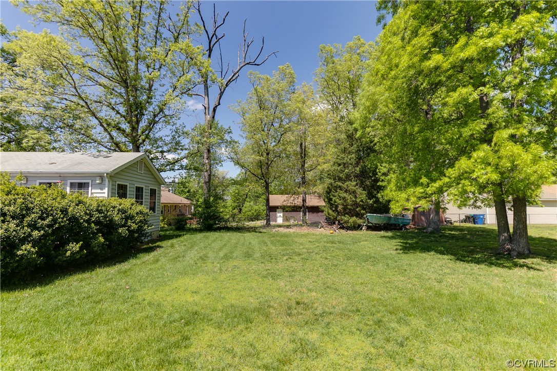 11606 Genito Road Midlothian, VA 23112 - Photo 45 of 48 a view of a house with a big yard and large trees