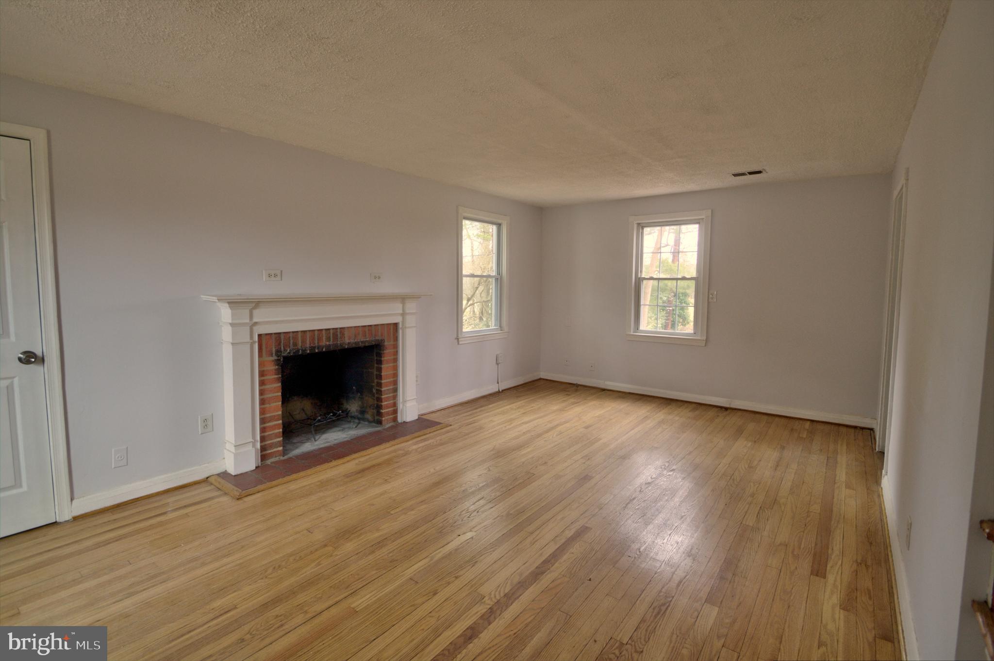 7031 Concord Road Pikesville, MD 21208 - Photo 3 of 51 Refinished hardwood living room floors w/fireplace