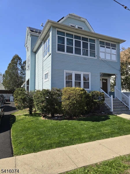170 Spring Street Passaic, NJ 07055 - Photo 1 of 16 a front view of a house with a yard