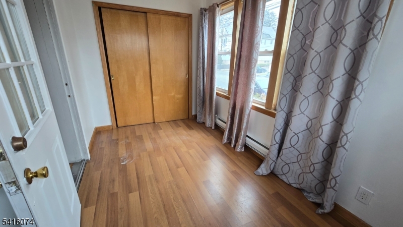 170 Spring Street Passaic, NJ 07055 - Photo 13 of 16 a view of an entryway with wooden floor and door