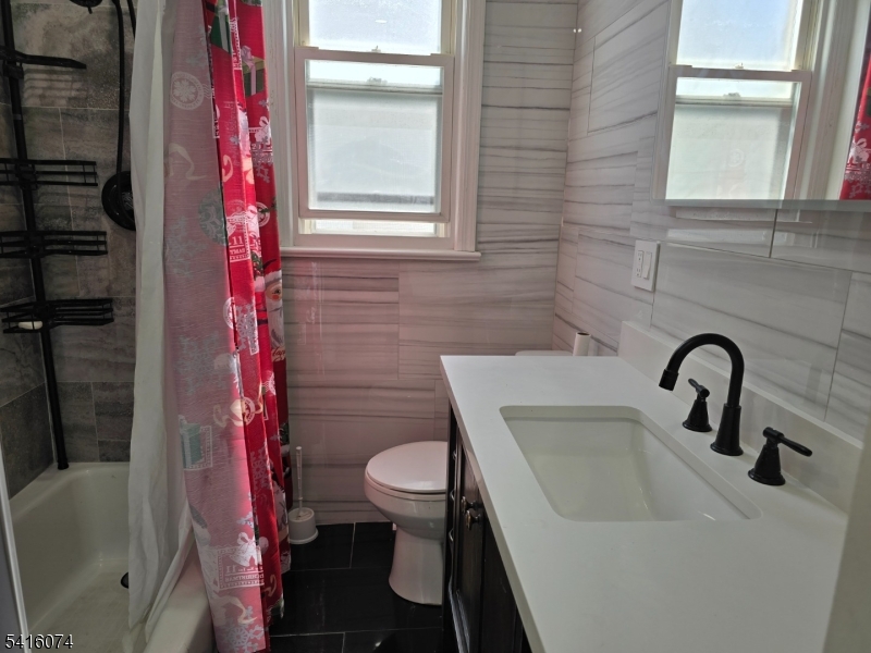 170 Spring Street Passaic, NJ 07055 - Photo 16 of 16 a bathroom with a sink toilet and shower