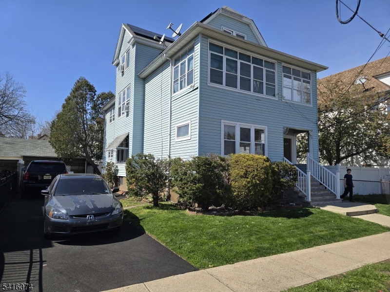 170 Spring Street Passaic, NJ 07055 - Photo 2 of 16 a front view of a house with a garden
