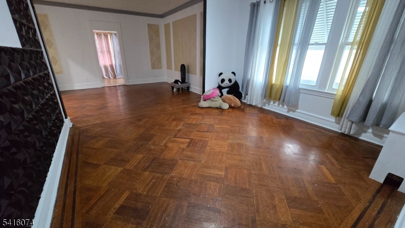 170 Spring Street Passaic, NJ 07055 - Photo 2 of 11 a view of empty room with two windows