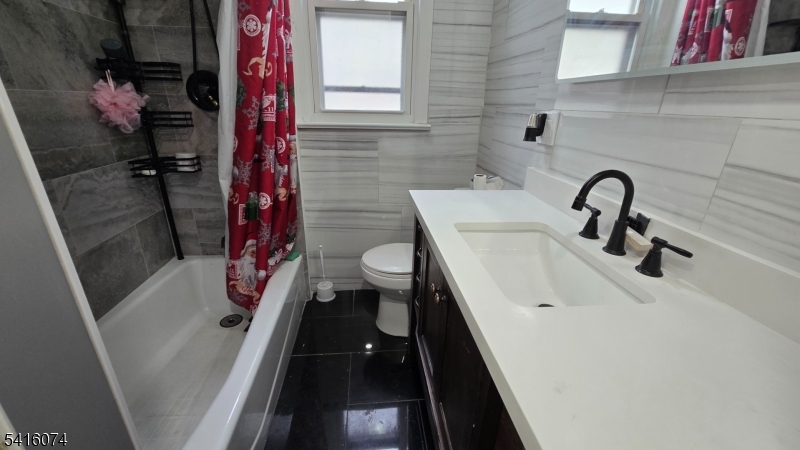 170 Spring Street Passaic, NJ 07055 - Photo 5 of 11 a bathroom with a sink toilet and shower