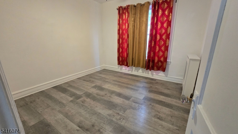 170 Spring Street Passaic, NJ 07055 - Photo 7 of 11 a view of a room with red walls and a window