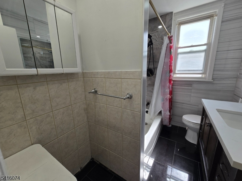 170 Spring Street Passaic, NJ 07055 - Photo 8 of 16 a bathroom with a toilet and a shower