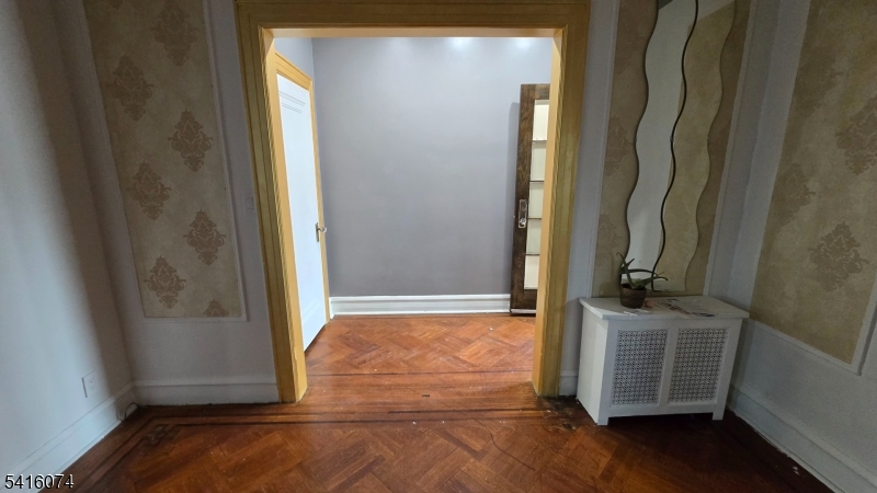170 Spring Street Passaic, NJ 07055 - Photo 10 of 11 a view of front door with wooden floor