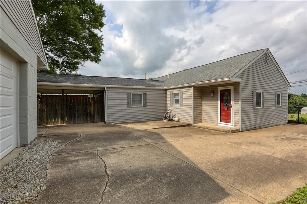 139 Miller Road Rochester, PA 15074 - Photo 25 of 33 a view of a house with a patio and a yard