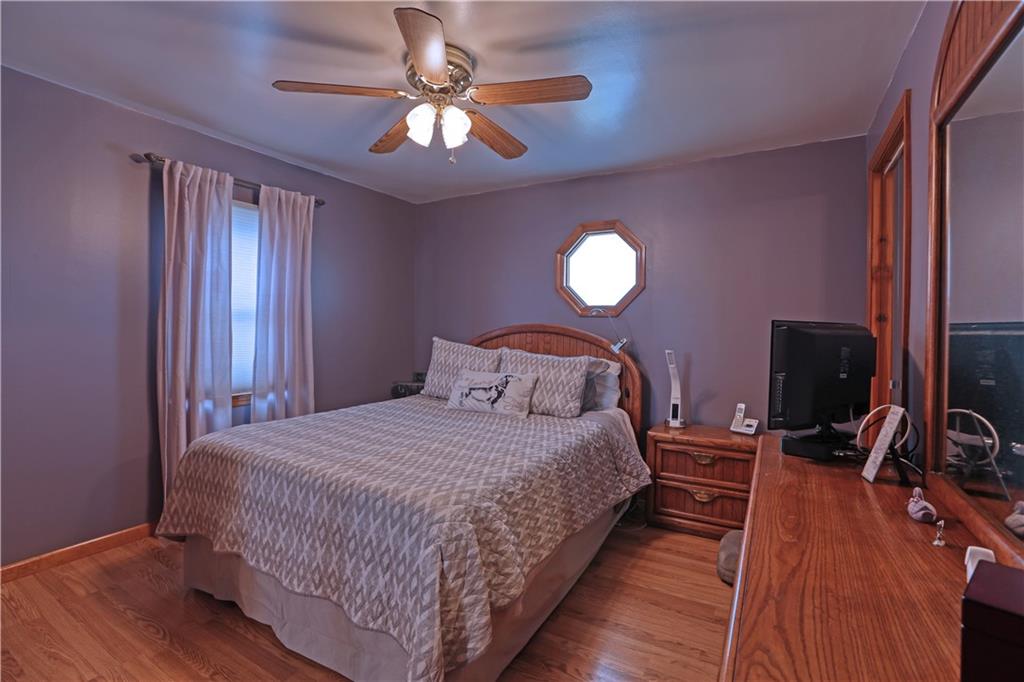 139 Miller Road Rochester, PA 15074 - Photo 10 of 33 a bedroom with a bed and wooden floor