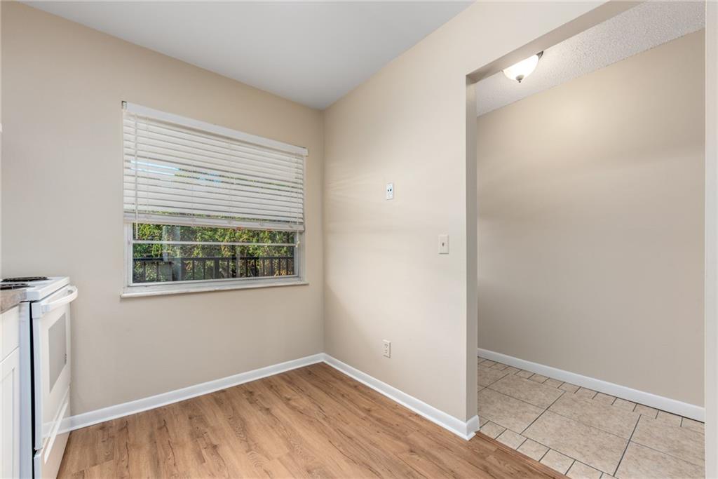 333 Southeast Martin Avenue, Unit 57 Stuart, FL 34996 - Photo 11 of 16 a view of an empty room with wooden floor and a window