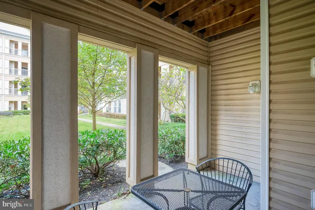 a view of a dining room with furniture large windows and wooden floor