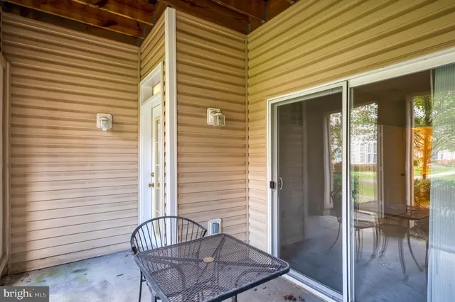 a view of a dining room with furniture large windows and wooden floor