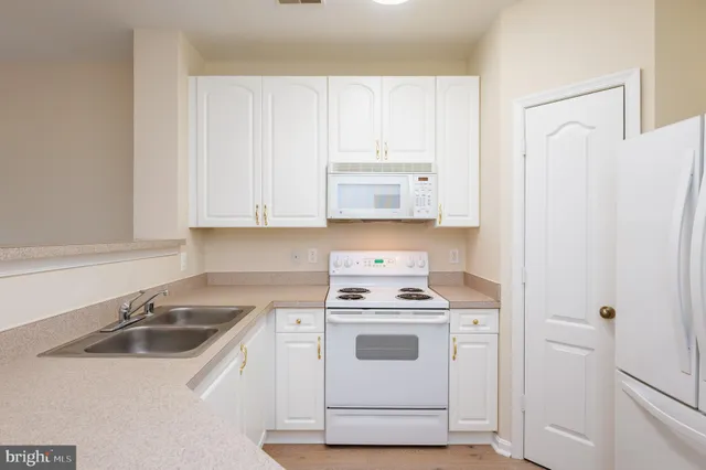 a view of a room with a window and wooden floor