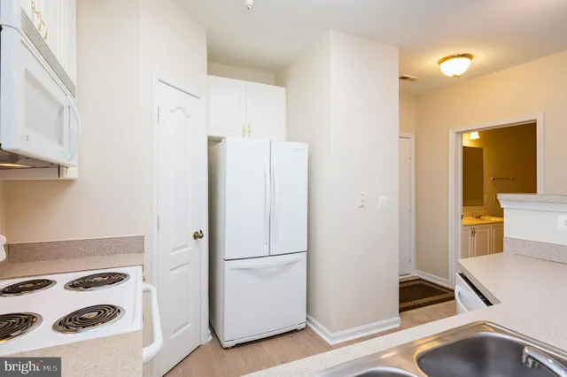 a view of a room with wooden floor and a ceiling fan