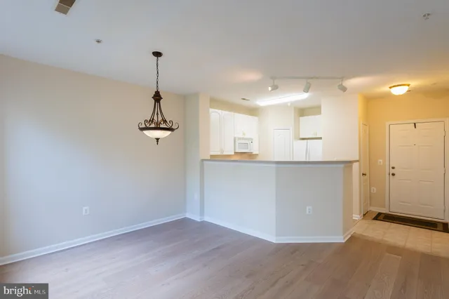 a view of a kitchen with a refrigerator and window
