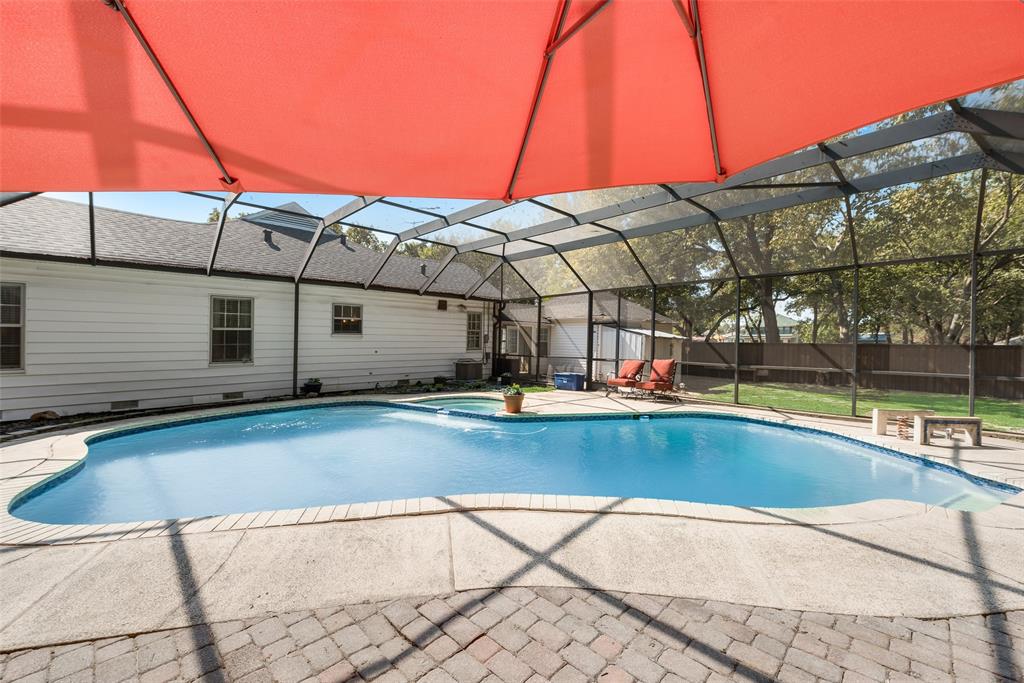 233 East High Street Wills Point, TX 75169 - Photo 39 of 40 Integrated pool / spa with glass enclosure, a patio area, and a sunroom