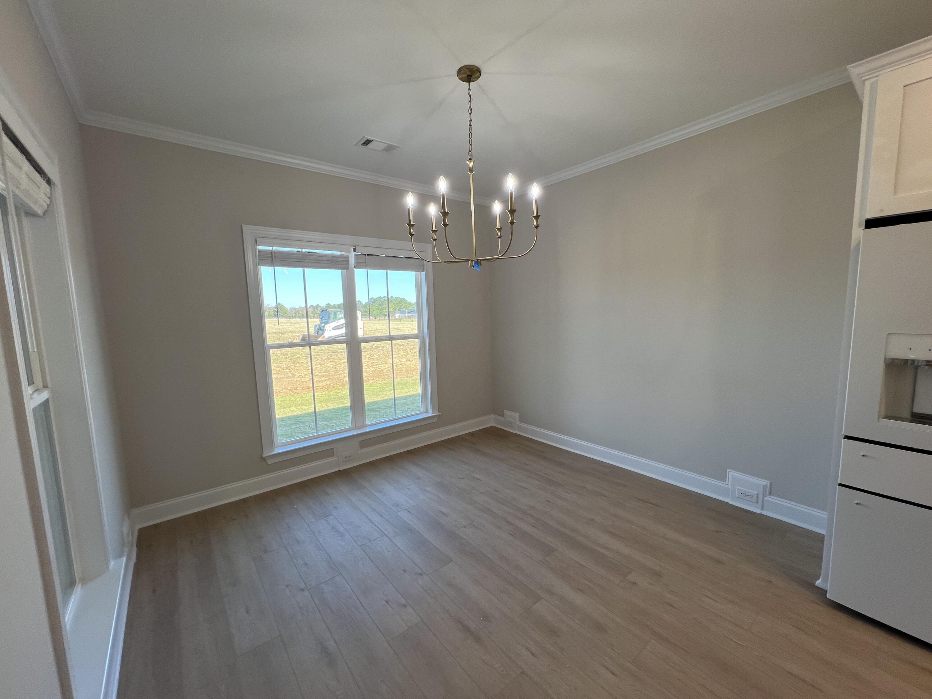 2747 Storm Branch Road Beech Island, SC 29842 - Photo 11 of 38 wooden floor in an empty room with a window
