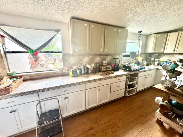 a kitchen with sink cabinets and wooden floor