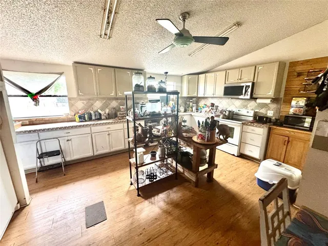 a very nice looking living room with a large window and stainless steel appliances