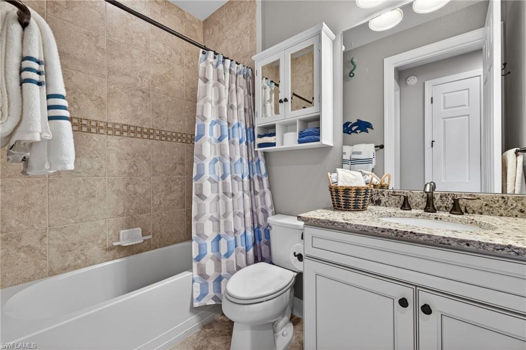 20105 Torch Key Way Estero, FL 33928 - Photo 19 of 29 a bathroom with a granite countertop sink toilet and shower