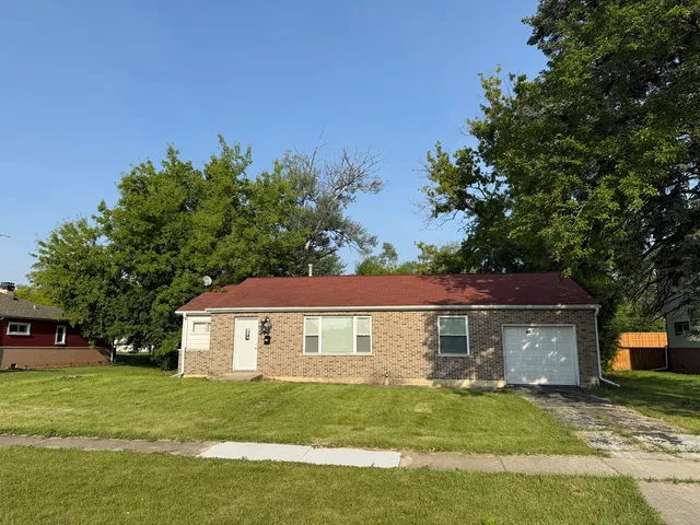 a view of a yard in front of a house with large trees