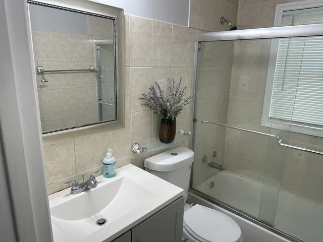 a bathroom with a shower a toilet and a sink