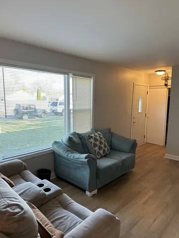 a living room with furniture and floor to ceiling window