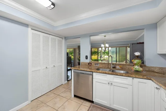 a dining room with furniture a chandelier and wooden floor