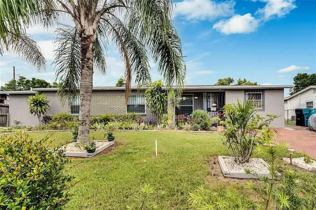 a front view of a house with swimming pool having outdoor seating