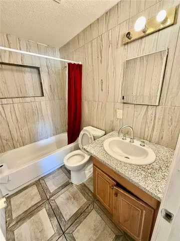 a view of a livingroom with wooden floor and furniture