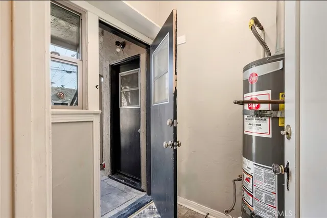 a front view of a multi story residential apartment building with yard and sign board