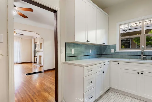 a view of empty room with wooden floor and fireplace
