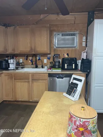 a kitchen with sink cabinets and window