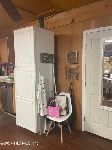 a view of a bedroom with a bed and furniture