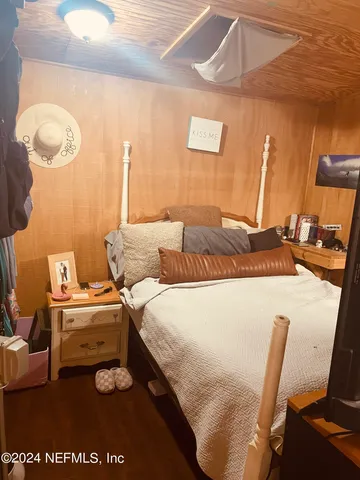 a bedroom with a bed and chair